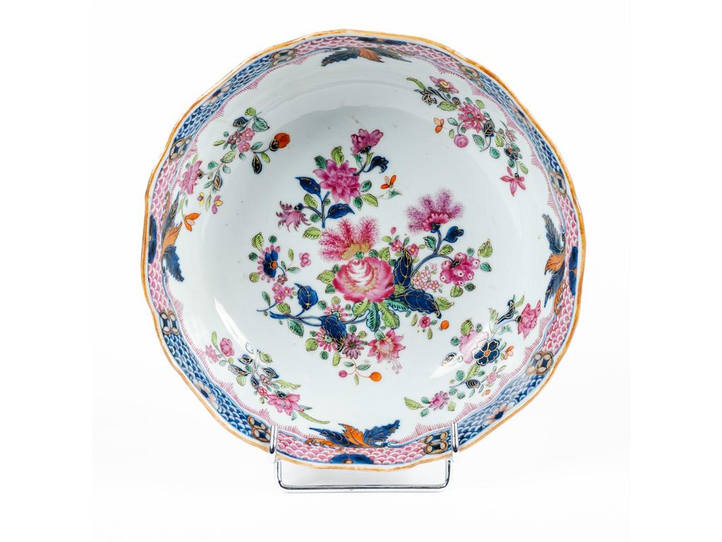 CHINE : Petit saladier en porcelaine blanche à décor peint de bouquets de fleurs. Aile surlignée d'un liseré d'écaille. Epoque XIXème siècle. (Fêle). Hauteur : 6 cm. Diamètre : 22.5 cm.