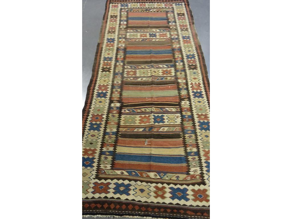 IRAN : Tapis Kilim à décor géométrique polychrome. (Usures et accrocs). Dim : 280 x 120 cm.