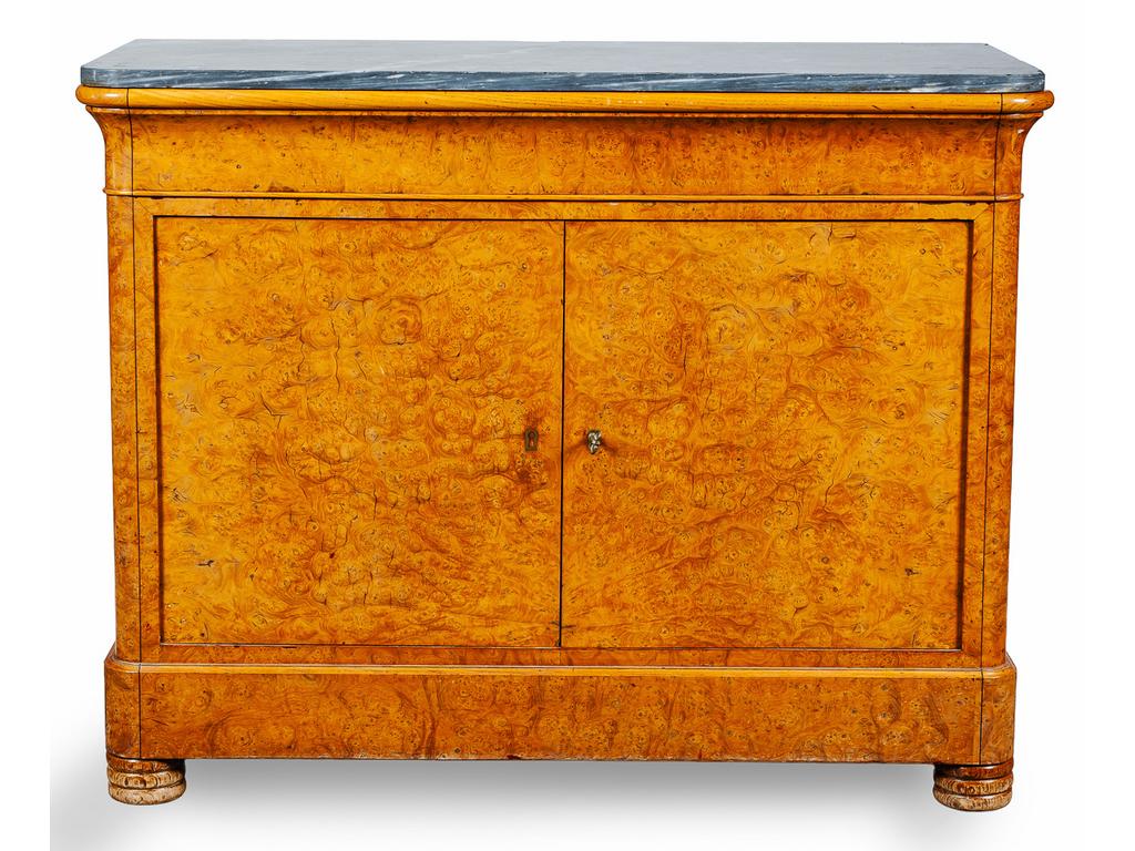 Commode à portes d'époque Restauration, en placage de bois ronceux, ouvrant en ceinture par un tiroir et deux vantaux découvrant trois tiroirs en placage de bois clair. Plateau de marbre bleu turquin. (Côtés avec fentes au placage, rayures et éclats au marbre). Dim : 101 x 130 x 60 cm.