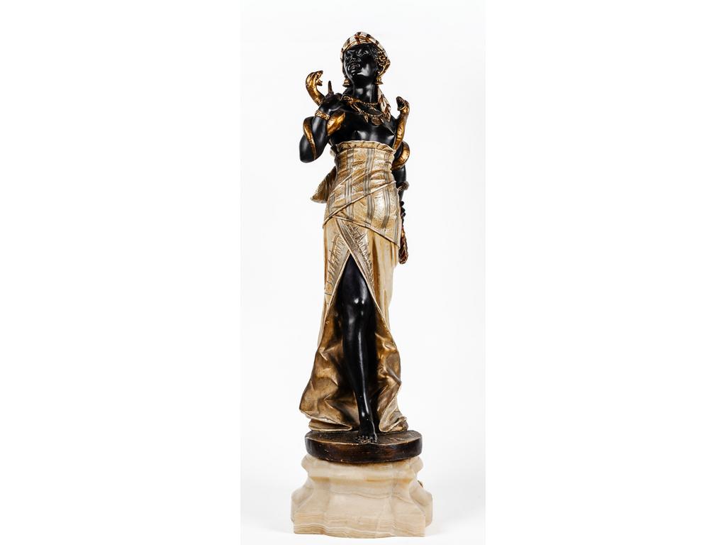 Importante sculpture en terre cuite patinée figurant une charmeuse de serpent et reposant sur un socle en albâtre. Trace de signature sur la terrasse (illisible). Vers 1900. (Cassée recollée, petits éclats et un angle du socle cassé-recollé). Hauteur totale : 113 cm.