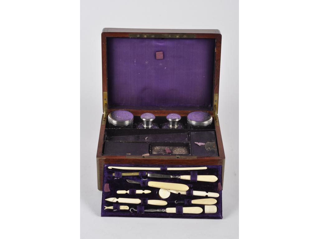 Coffret de toilette et manucure en acajou sur monture en laiton. Signée TH.ANNEE, rue Chapon, 18, Paris. Comprenant des ustensiles en os et ivoirine (quelques manques), deux flacons et deux boîtes rondes en verre avec couvercle en argent (fente au couvercle).