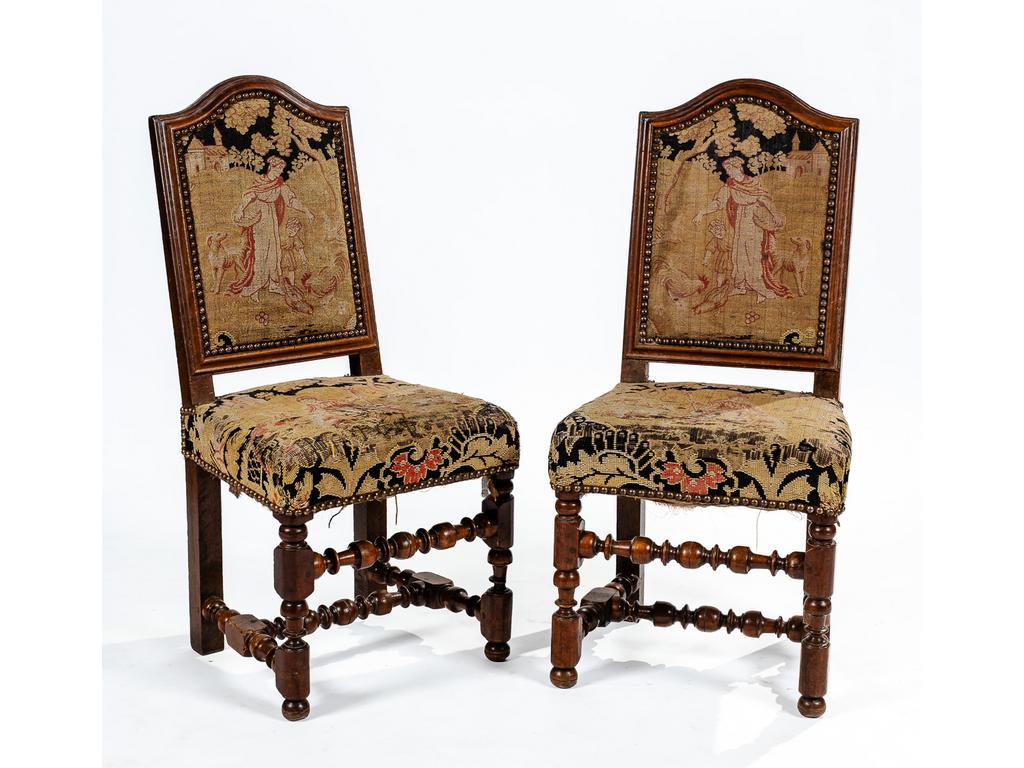 Paire de chaises de style Louis XIII en noyer reposant sur des pieds tournés à entretoises. Garniture au point de croix. (Déchirures et trous de xylophages).
