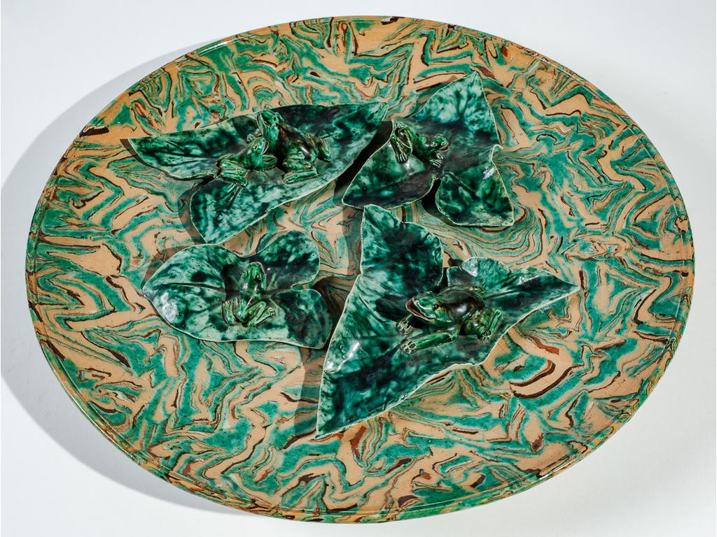 Manufacture PICHON à Uzès : Important plat rond à décor en relief de grenouilles et de nénuphars dans le goût de Palissy sur fond marbré en terres mêlées. Signé du cachet de François PICHON. (Fêle). Diamètre : 44 cm.