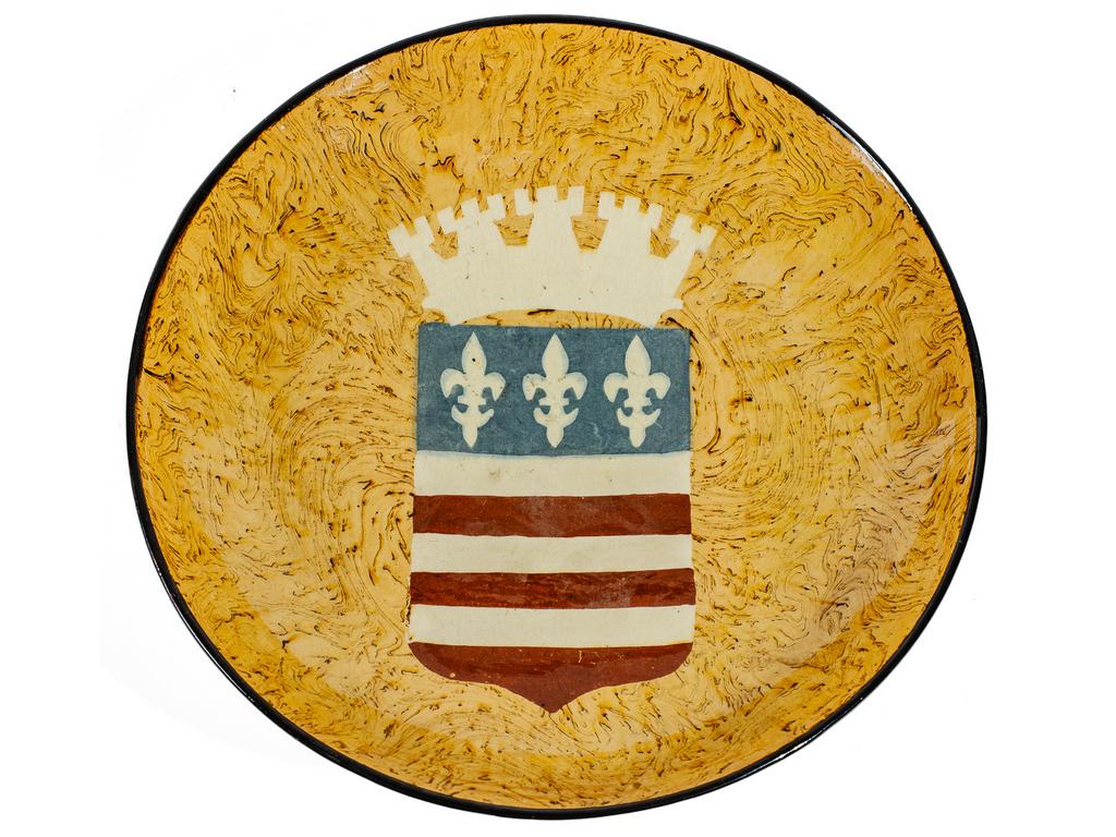 Manufacture PICHON à Uzès : Important plat creux circulaire orné du blason du Duché d'Uzès sur fond marbré en terres mêlées ocres. Signé du cachet de François PICHON. Diamètre : 35,5 cm.