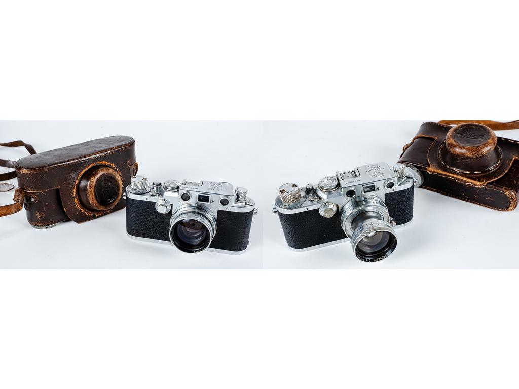 LEICA : Deux appareils photographiques modèles IIIf avec leurs étuis en cuir, , numérotés : 626348(seconde série 1952-1953, gammes de vitesses  en chiffres rouges) et 620071. On y  joint un coffret en cuir à compartiments garnis de velours bordeaux, contenant : deux objectifs de longue focale , un boîtier de visée à miroir coudé , deux réflecteurs de flash chromés avec leurs étuis en cuir , trois boîtes rondes en bakélite rouge, dont une renfermant un petit accessoire. Ensemble ancien, complet en apparence, présentant des marques d'usage normales.