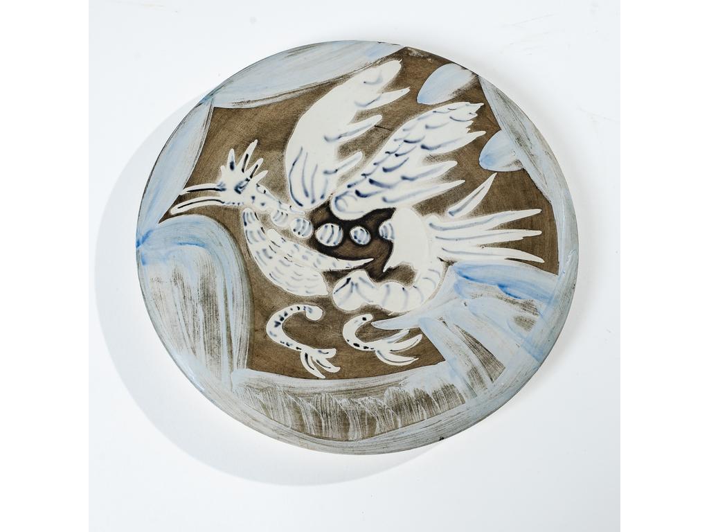 PABLO PICASSO (1881-1973) & ATELIER MADOURA : « Oiseau n° 91 » modèle créé en [1963], épreuve numérotée 143/150. Assiette ronde sur talon. Réplique authentique de lédition limitée à cent cinquante exemplaires numérotés et réalisés chez Madoura. Epreuve en terre de faïence blanche , décor à lengobe et émail sous couverte partielle au pinceau, patine noire. Marquée N° 91 Edition PICASSO MADOURA et numérotée 143/150 au pinceau au revers. D. 25,5 cm. Très légères usures démail sur larête du pourtour au revers. Bibliographie : Alain Ramié - Picasso, catalogue de l'uvre céramique édité 1947-1971 - Editions Madoura, 1988. Modèle identique reproduit page 249 sous le numéro 485 du catalogue. Expert : Emmanuel Eyraud.