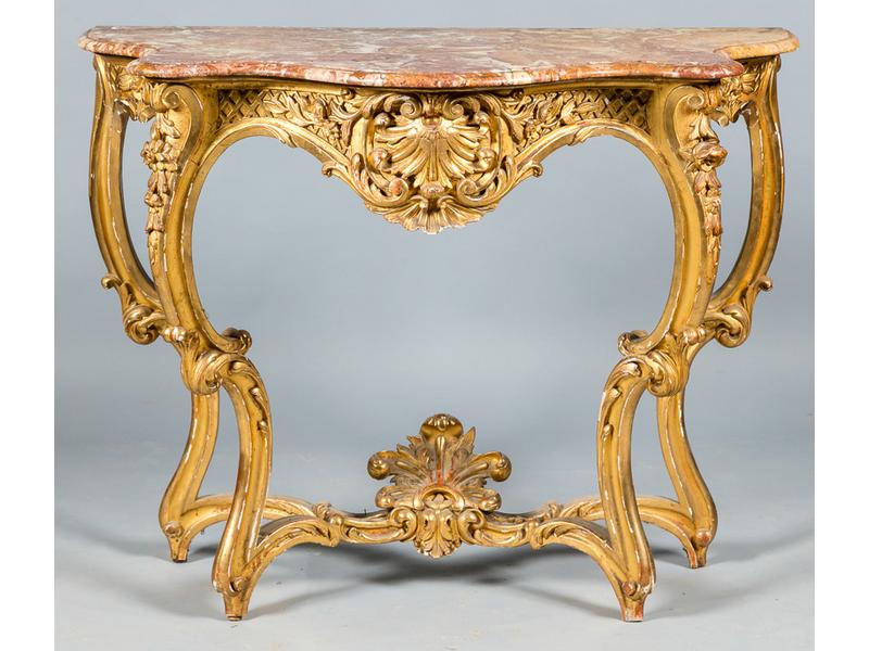 Ensemble comprenant :  Une console en bois et stuc doré de style Louis XV présentant une ceinture ornée d'une large coquille centrale entourée de branchages et treillages fleuris reposant sur quatre pieds cambrés réunis par une entretoise surmontée d'une coquille.  Plateau de marbre.  Epoque Napoléo