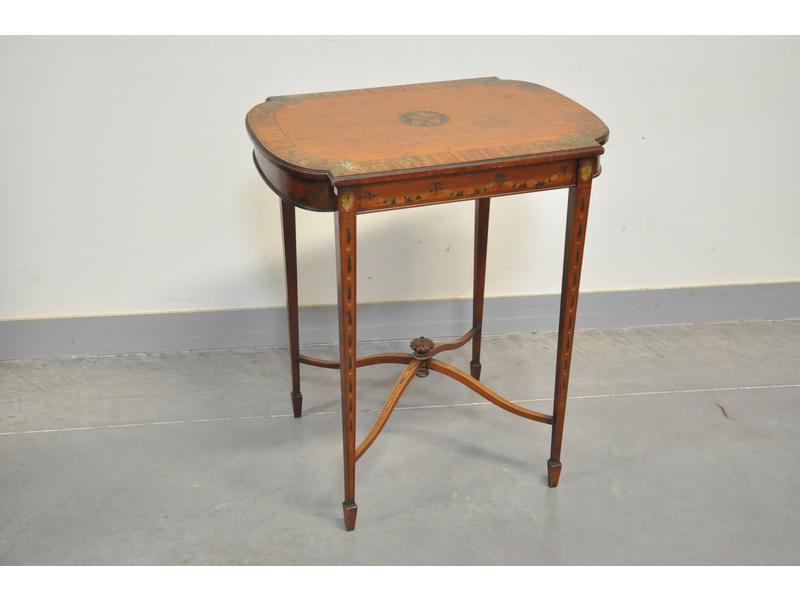 Petite table de salon en bois fruitier et à décor peint de quatre visages d'enfants au centre et de feuillages. Travail décoratif italien. Dimensions : 70x61x45 cm.