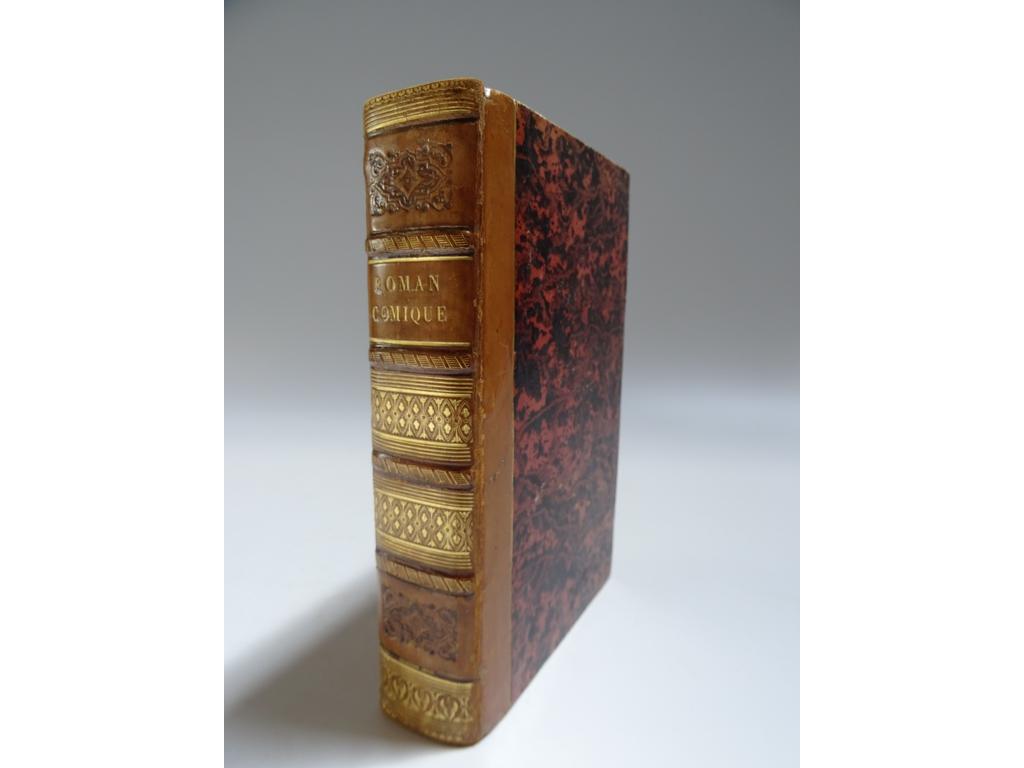 SCARRON : Le roman comique. Paris : Janet et Hubert, De limprimerie de Didot Jeune, An quatrième (1796). 3 parties en un volume in-8°. Reliure circa 1820-1830 demi-veau blond, dos à nerfs surmontés de roulettes hachurées dorées, roulettes dorées et fleurons à froid romatiques. Reliure signée par THOUVENIN-JEUNE. Bien complet de son portrait en frontispice d'après Deseine et de ses15 planches hors-texte gravées par Baquoy, Dambrun, Duclos, Hubert, Patas, Petit, Romanet et Simonet d'après LE BARBIER. Légers frottis, quelques rousseurs. TRES BEL EXEMPLAIRE, en reliure romantique signée.