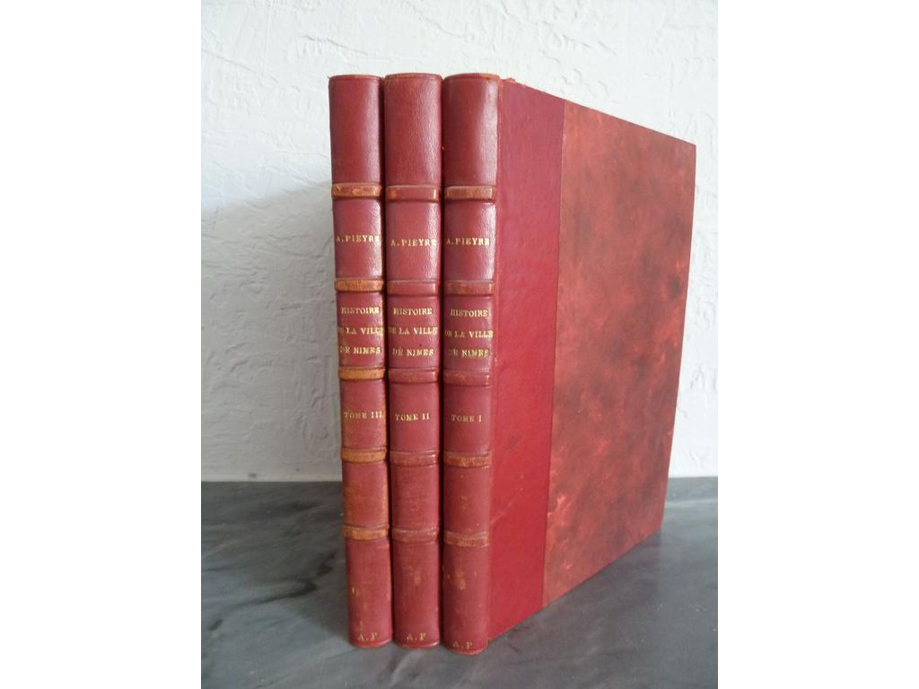 PIEYRE, Adolphe : Histoire de la ville de Nîmes depuis 1830 jusqu'à nos jours. Nîmes : Catelan : 1886.  3 volumes grand in-8°. Reliures 1ère moitié du XXe, demi-basane rouge, dos à 4 nerfs sautés janséniste Portrait en frontispice du 1er tome. Quelques frottis. BONS EXEMPLAIRES. Rare complet.