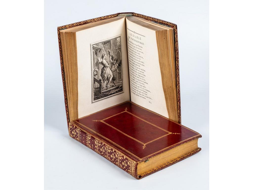 LA FONTAINE. (EISEN, Charles) : Contes et nouvelles. Amsterdam [Paris] : s.n [Barbou], 1762. 2 volumes in-8°. Reliures de lépoque plein maroquin rouge, dos lisses ornés de caissons de double filet doré richement et finement ornés, double encadrement de triple filet doré sur les plats avec fleurons aux angles de lencadré intérieur, roulettes dorées sur chasses et coupes, toutes tranches dorées. Célèbre édition dite des « Fermiers généraux » illustrée dun portrait de La Fontaine interprété par Ficquet d'après Rigaud, un portrait de Charles Eisen par le même d'après Vispré, 80 hors-texte daprès Charles EISEN gravées sur cuivre par Aliamet, Baquoy, Choffard, Longueil, 2 vignettes sur titre, 2 en-têtes et 53 culs-de-lampe par Choffard. Les gravures du Cas de conscience et du Diable de Papefiguière sont couvertes. La gravure de Féronde est dans son état avant le bonnet, celle de l'Autre imitation d'Anacréon dans son état avec la flèche, celle du Roi Candaule dans son état sans le plateau sous la jambe de la reine, celle d'Alix malade comme celle du Remède sont avec ornements sur les rideaux. Les « avis au relieur » sont bien présents in-fine de chaque tome. Cohen : 558 : « Cette édition [...], dite des Fermiers généraux, parce qu'ils en firent les frais, est celle dont l'ensemble est le plus beau et le plus agréable , c'est, en outre, le chef-d'uvre d'Eisen ». (Rochambeau : 529, n°79. Hédé-Haüy : 29). Rarissimes rousseurs, SUPERBE EXEMPLAIRE, à belles marges (177x118mm), dans un maroquin de lépoque dune grande finesse et parfaitement conservé et présentant les gravures dans un beau tirage.
