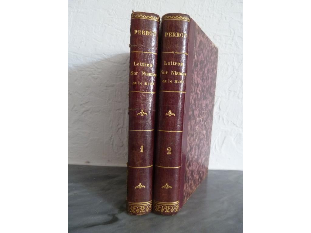 PERROT, J.F.A. : Lettres sur Nismes et le Midi, histoire des monuments antiques du Midi de la France. Nismes : Chez lauteur, 1840. 2 volumes in-8°. Reliures de lépoque, demi-basane violine, dos lisses ornés de filet et fleurons dorés. Illustré de vignettes sur titre, quelques in-texte, 62 planches hors-texte dont 4 dépliantes. Dos du tome 1 recollé, rousseurs parfois fortes, quelques mouillures et autres défauts.