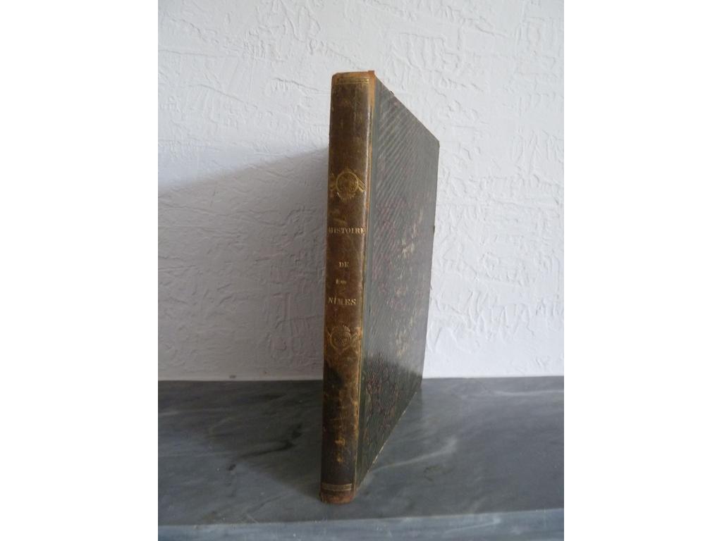 NISARD, Désiré : Histoire et description de Nîmes. Paris : Chez Desenne, 1842. Un volume in-4°. Reliure de lépoque demi-Basane vert bronze, dos lisse orné de fleurons et roulettes dorés. Bien complet de ses 6 belles gravures sur acier daprès Rouargue, Havell, Allom, dont frontispice et de 4 gravures sur bois dans un large encadrement festonné, toutes hors-texte. Frottis et rousseurs éparses. BON EXEMPLAIRE, ici au format in-4°.