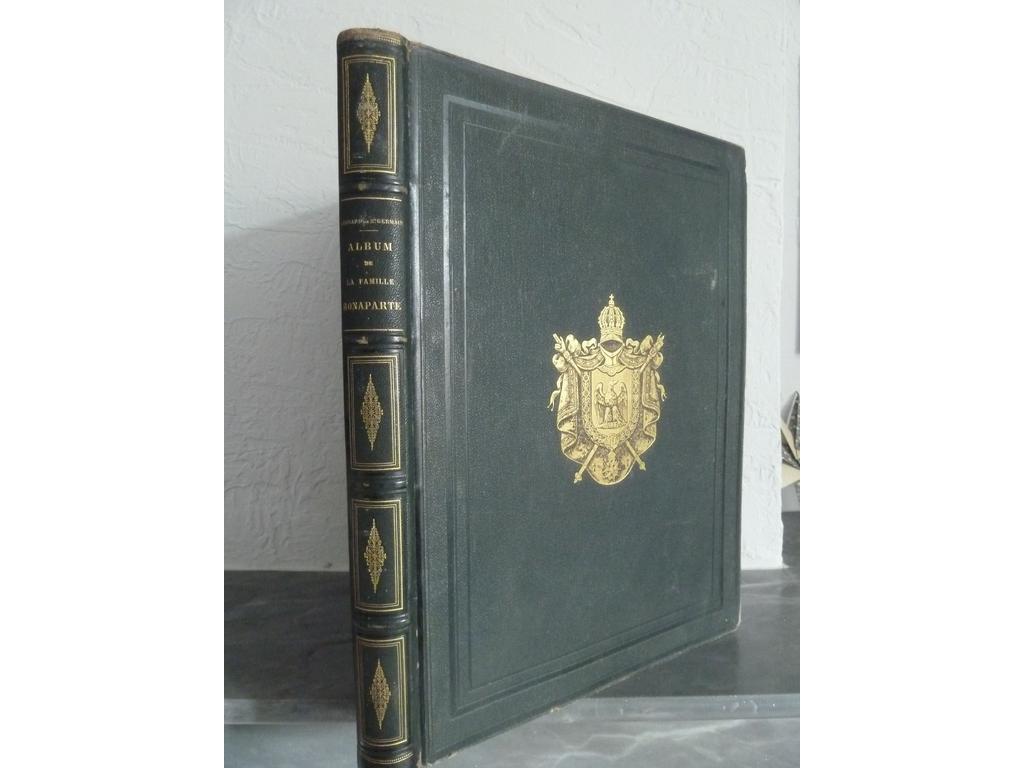 ALBUM DE LA FAMILLE BONAPARTE. Reproduction des portraits originaux légués à la ville d'Ajaccio par Madame Mère par Léonard de St Germain Photographe à Nice. S.l.n.e., 1866. 1 volume in-folio. Reliure de léditeur demi-chagrin vert cyprès, dos à nerfs simulés ornés de caissons de triple filet doré fleuronnés, plats de percaline chagrinée de même teinte ornés de filets à froid en encadrement des armoiries dorées de la famille Bonaparte, toutes tranches dorées. Bien complet de son titre, les armoiries de la Corse, et de ses 38 épreuves sur papier albuminé dont 32 reproductions d'uvres et documents relatifs à la famille Bonaparte et 6 photographies) montrant les lieux de Corse se rapportant aux Bonaparte (maison natale de Napoléon Ier. Vue de la Chapelle Bonaparte...), ainsi in-fine une reproduction de laigle impériale (au total 41 feuillets), le tout appliqué sur carton fort et monté sur onglets. Quelques rares rousseurs et frottis sinon BEL EXEMPLAIRE, peu commun pour  cet ouvrage des collections léguées par Madame Mère à Ajaccio.