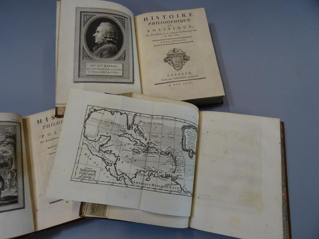 RAYNAL, Abbé : Histoire philosophie et politique des établissements et du commerce des européens dans les deux Indes. Genève, Chez les libraires associés, 1775. 3 volume in-4°. Reliures de lépoque plein veau porphyre, dos à nerfs ornés de caissons de double filet doré fleuronnés, pièces de titre en maroquin rouge te de tomaison en maroquin noir, double filet doré sur coupes, toutes tranches marbrées. Bien complet de ses 3 frontispices dont un portrait de lauteur gravé par Legrand daprès Cochin, une vignette sur titre, 4 cartes dépliantes, 3 en-tête de Marillier et 5 hors-texte. Cet ouvrage est du notamment à la collaboration de Didreot, Holbach et Dutesta. Quelques défauts aux reliures, quelques cahiers brunis néanmoins TRES BEL EXEMPLAIRE.