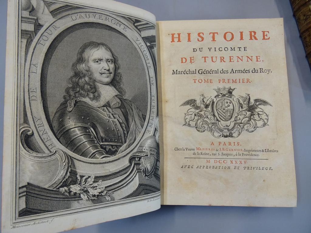 (Turenne) [RAMSAY, A.M de] : Histoire du Vicomte de Turenne, Maréchal général des armées du Roy. Paris : Mazieres et Garnier, 1735. 2 volumes grand in-4°. Reliures de lépoque plein veau fauve, dos à nerfs ornés de caissons de double filet dorés fleuronnés, pièces de titre et de tomaison en maroquin grenat, double filet doré sur coupes, toutes tranches rouges. EDITION ORIGINALE bien complète de son portrait en frontispice, de ses 2 vignettes armoriées sur titre, de ses 7 en-tête daprès Scotin (un non signé), ses 7 belles lettrines ornées, et de ses 4 culs-de-lampe. Bien complet également de ses 10 planches hors-texte dépliantes représentant des plans de batailles. Henri de la Tour d'Auvergne-Bouillon, (1611- 1675, vicomte de Turenne, duc de Bouillon, Prince de Sedan, généralement connu sous le nom de Turenne. Maréchal de France en 1643 et maréchal général des camps et armées du roi en 1660, fut l'un des meilleurs généraux de Louis XIII, puis de Louis XIV. Quelques cahiers brunis, très pâle mouillure angulaire sans atteinte sur une vingtaine de feuillets, légers frottis sinon TRES BEL EXEMPLAIRE, bien conservé.